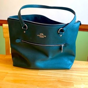 Green Coach tote with outside and inside zippered pockets. Two inside pockets